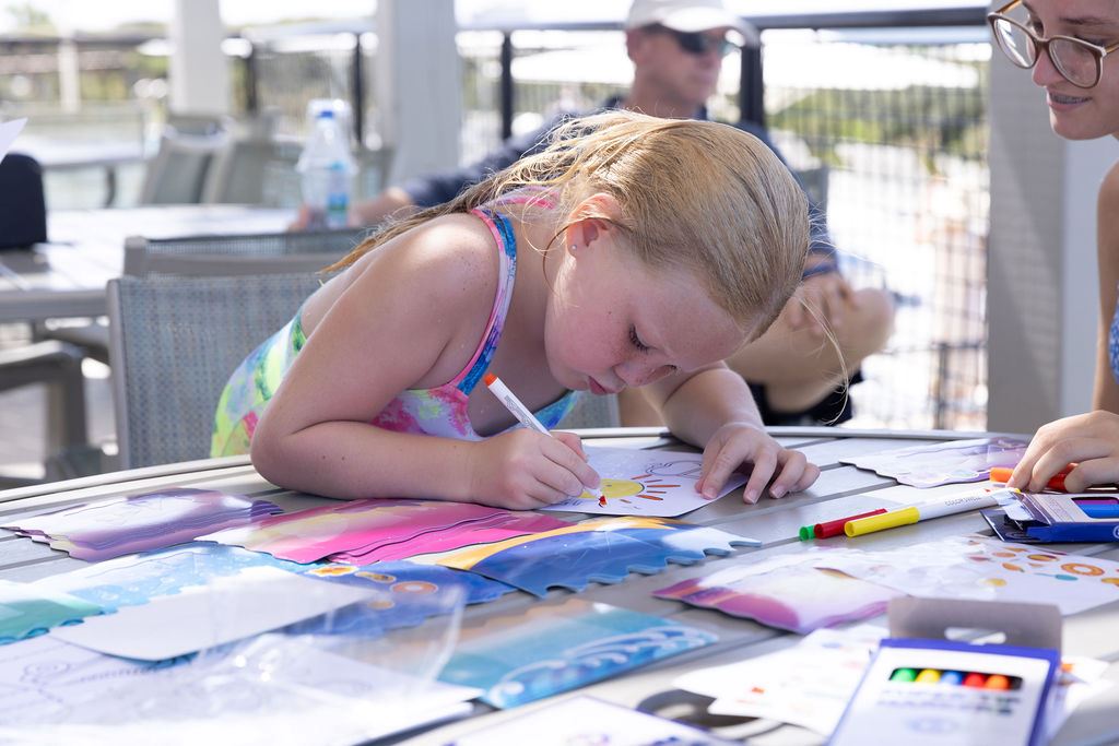 Little girl coloring an arts and crafts project at the Beach Club